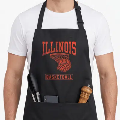 Fighting illinois university apron - Orange distressed ILLINOIS text above basketball net and BASKETBALL label — shown on a black cotton canvas apron against a white background