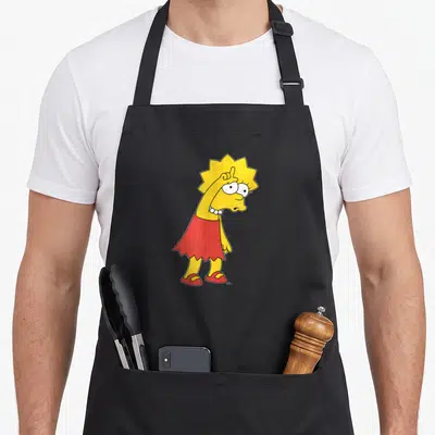 Lisa loser apron - Yellow cartoon girl in red skirt raising one finger, white pearls — shown on a black cotton canvas apron against a white background