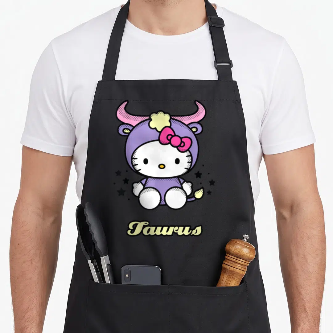Zodiac taurus aprons - Hello Kitty in purple bull costume with Taurus text and scattered stars — shown on a black cotton canvas apron against a white background