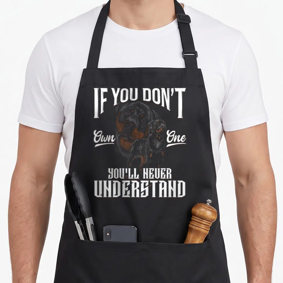 Youll rottweiler dog apron - IF YOU DON'T Own One YOU'll NEVER UNDERSTAND text with realistic dog head and full body — shown on a black cotton canvas apron against a white background