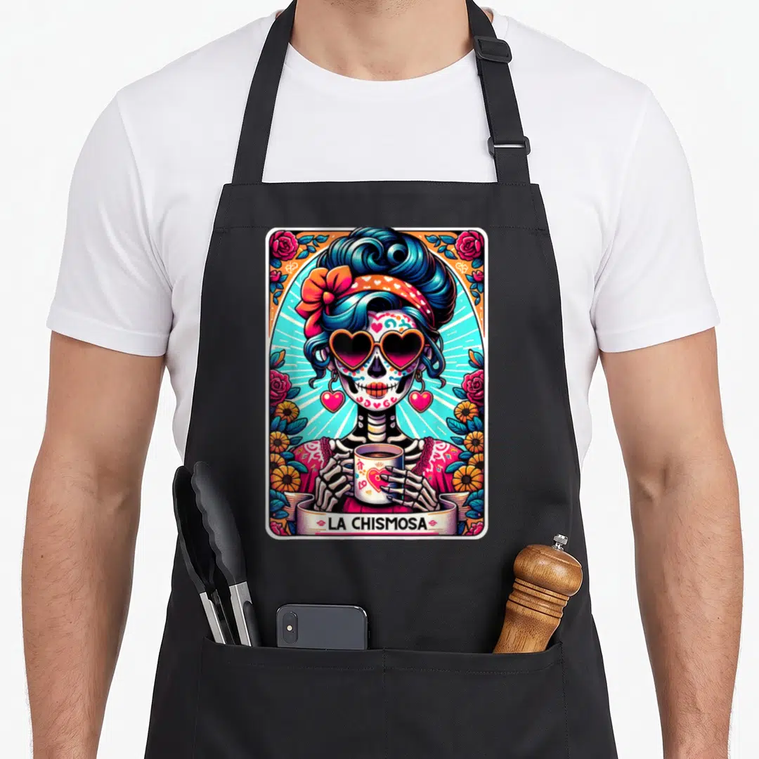 Chismosa mexican apron - Skeleton woman with heart sunglasses holding mug surrounded by roses and LA CHISMOSA text — shown on a black cotton canvas apron against a white background