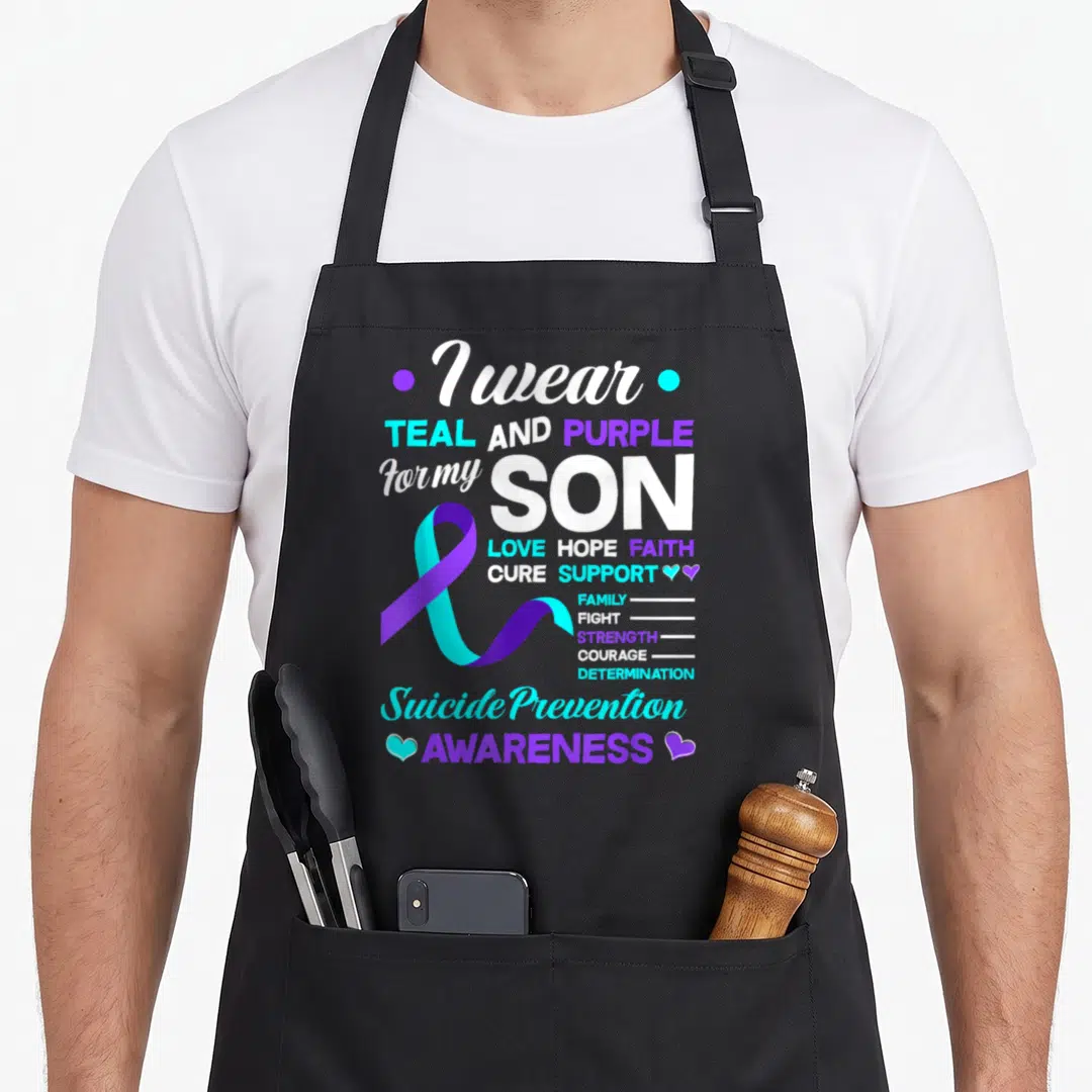 Son suicide prevention apron - I wear TEAL AND PURPLE for my SON text with teal purple ribbon and small hearts — shown on a black cotton canvas apron against a white background