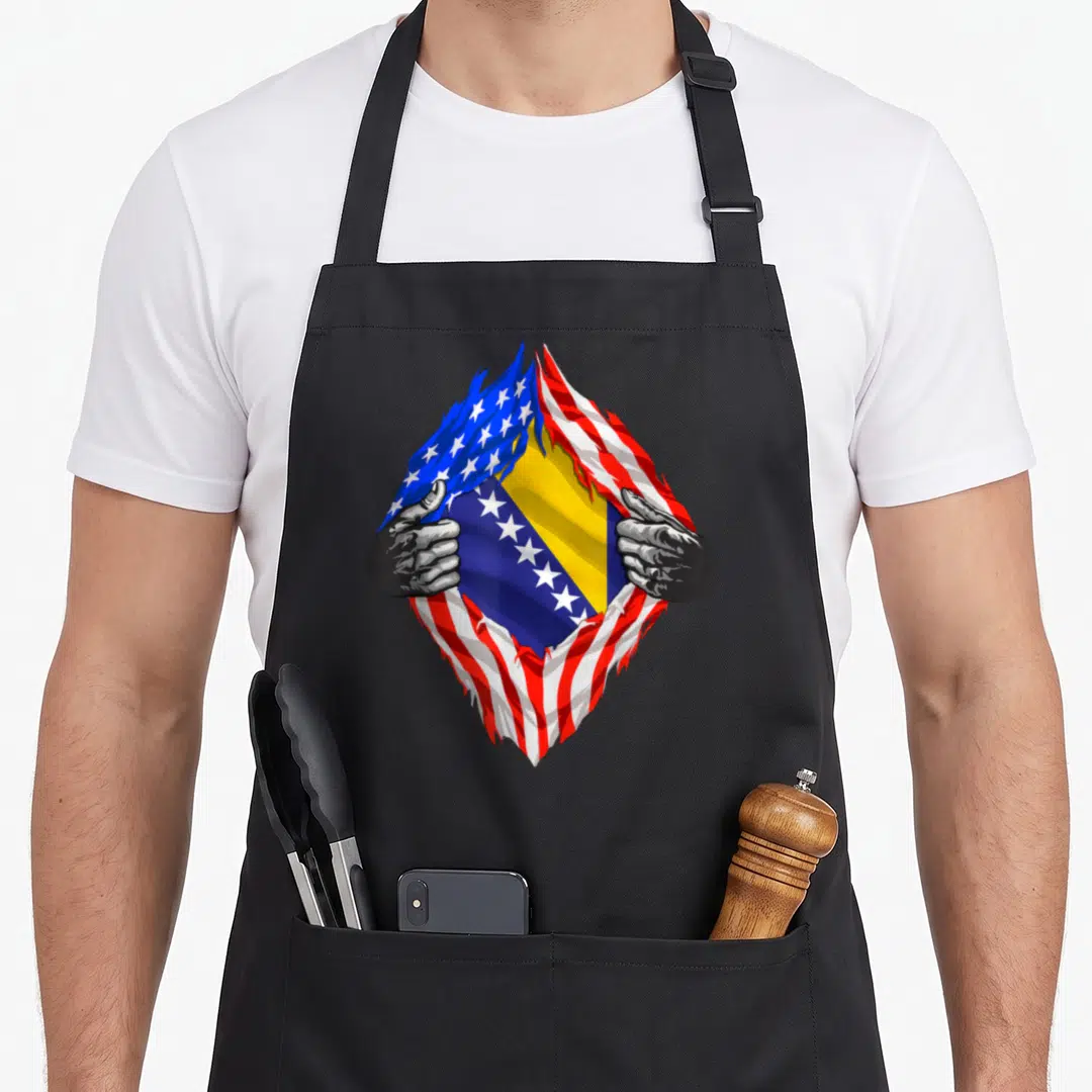 Bosnia american flag apron - Hands tearing USA flag to reveal Bosnia and Herzegovina flag in blue yellow red white — shown on a black cotton canvas apron against a white background