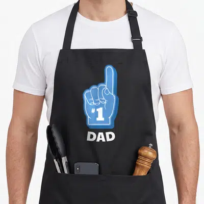 Foam father day apron - Blue foam finger pointing up with #1 on palm and DAD text below — shown on a black cotton canvas apron against a white background