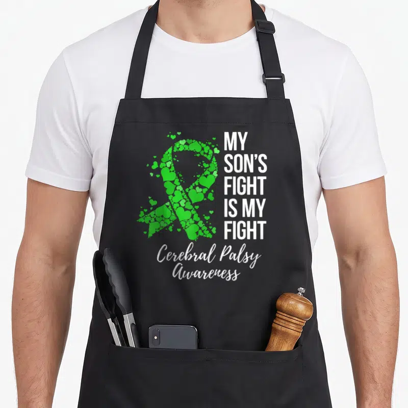 Son cerebral palsy awareness apron - Green heart ribbon and white text MY SON'S FIGHT IS MY FIGHT Cerebral Palsy — shown on a black cotton canvas apron against a white background