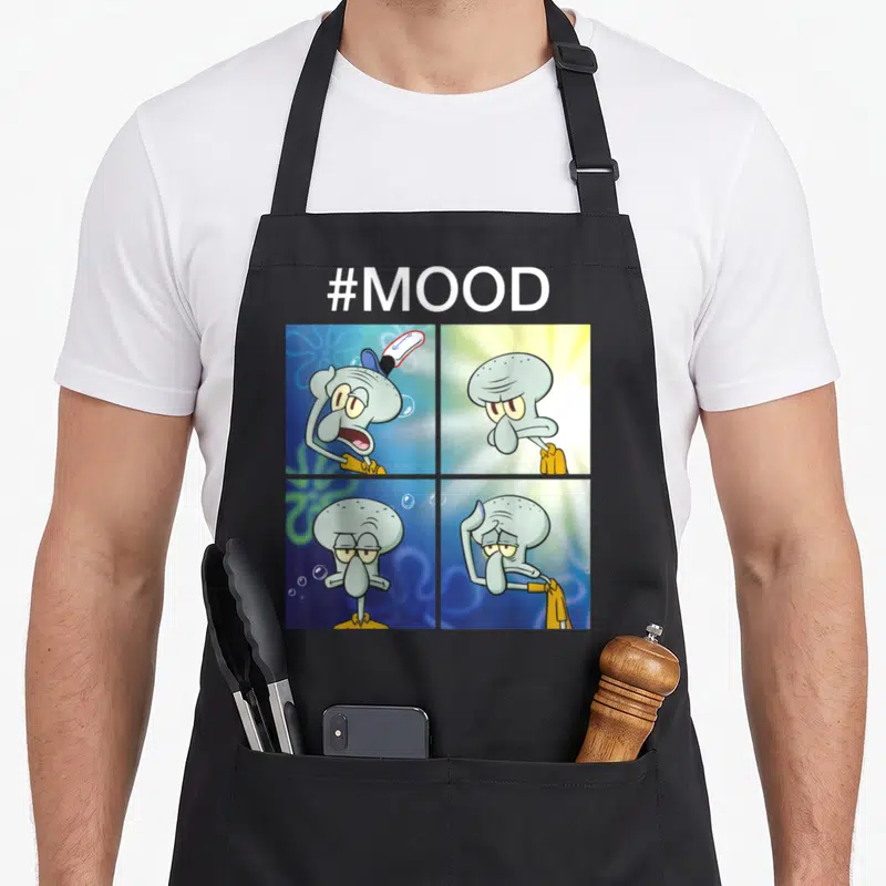 Squarepant meme apron - Squidward four panel expression grid with #MOOD text in blue and yellow cartoon style — shown on a black cotton canvas apron against a white background
