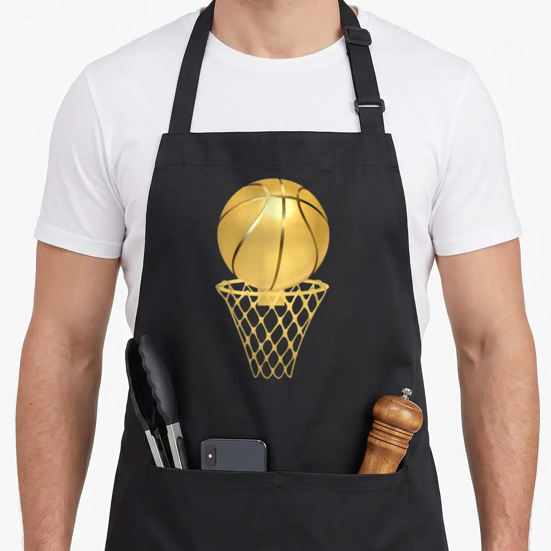 Basketball game aprons - Realistic gold basketball entering a gold net — shown on a black cotton canvas apron against a white background