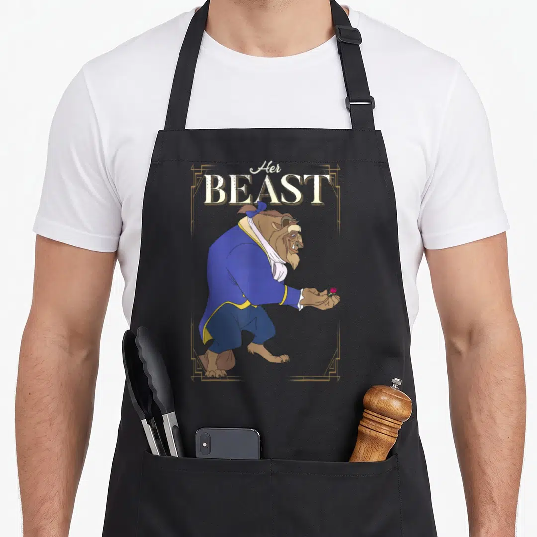 Framed beast mode apron - Stacked text Her BEAST above a cartoon beast in blue holding a rose inside a gold frame — shown on a black cotton canvas apron against a white background