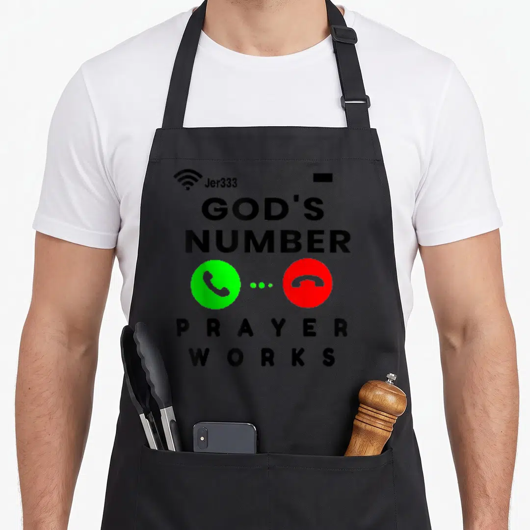 Writing prayer apron - Stacked text GODS NUMBER PRAYER WORKS with green accept and red decline phone buttons separated — shown on a black cotton canvas apron against a white background