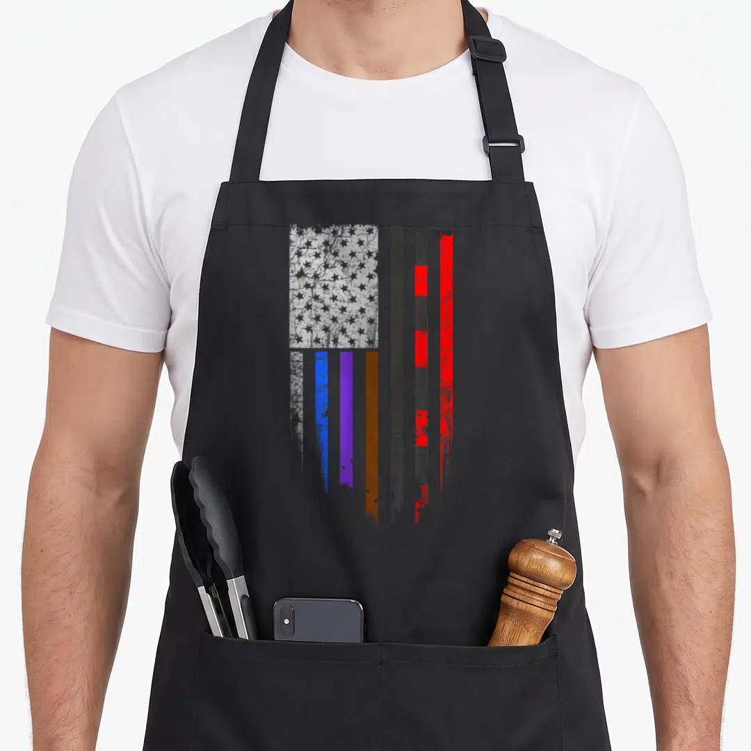 Bjj stripe apron - Distressed flag with star field and vertical stripes in white blue purple brown black and red — shown on a black cotton canvas apron against a white background