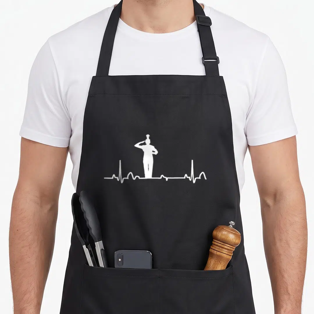 Drum major apron - White silhouette of a graduate standing on a heartbeat line graphic — shown on a black cotton canvas apron against a white background