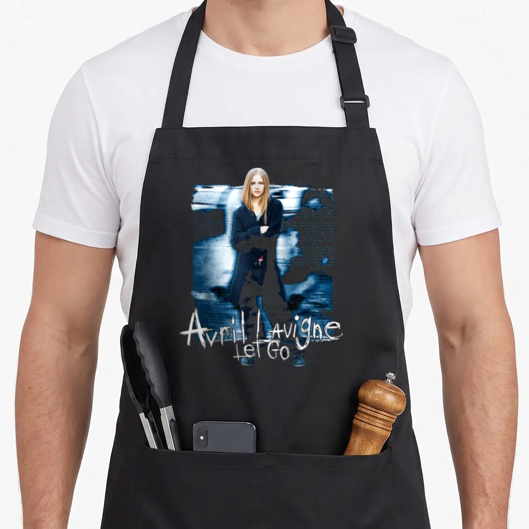 Avril novelty apron - Photo of Avril Lavigne over blue background with white text reading Avril Lavigne Let Go — shown on a black cotton canvas apron against a white background