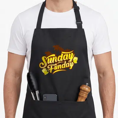 Funday beer apron - Yellow Sunday Funday text with brown palm trees and two beer mugs — shown on a black cotton canvas apron against a white background