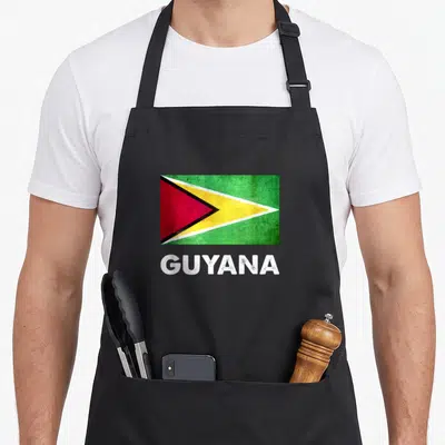 Flag georgetown guyana apron - Distressed Guyana flag in green yellow red white above white GUYANA text — shown on a black cotton canvas apron against a white background