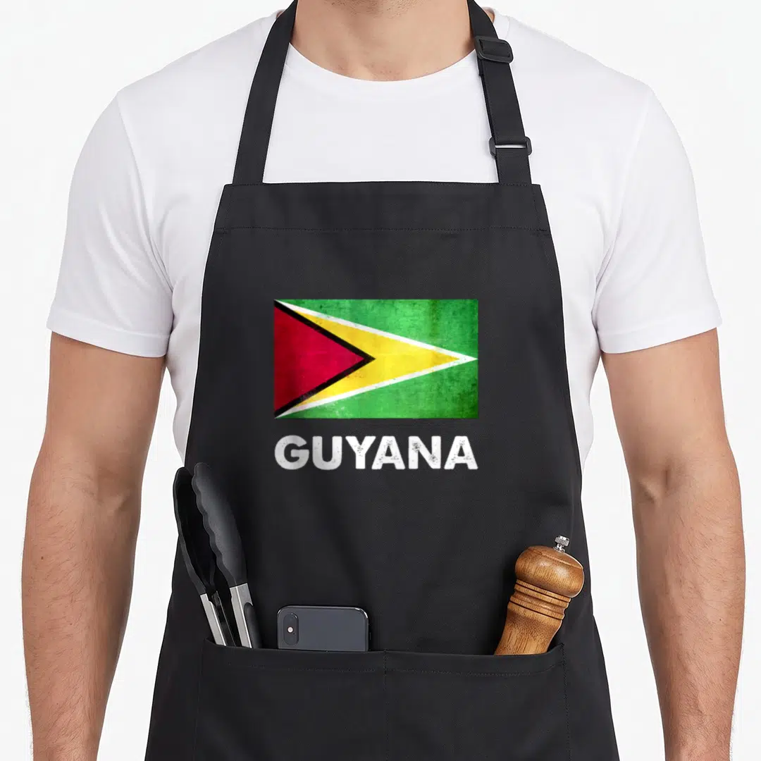 Flag georgetown guyana apron - Distressed Guyana flag in green yellow red white above white GUYANA text — shown on a black cotton canvas apron against a white background