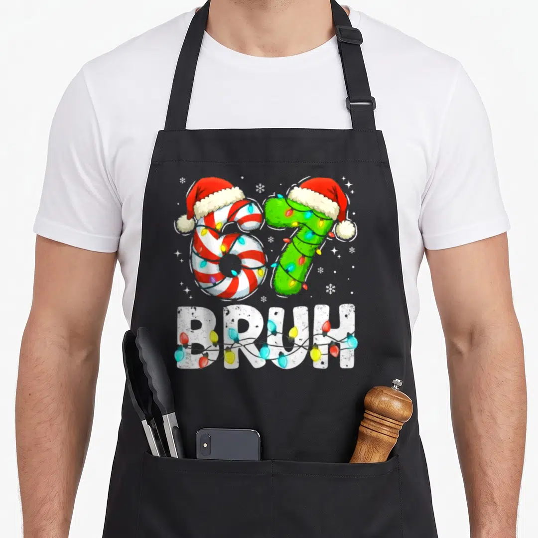 Bruh six christmas apron - Number 67 with Santa hats and lights below BRUH text — shown on a black cotton canvas apron against a white background