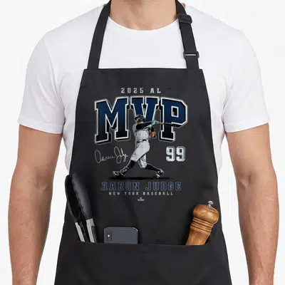 Mvp new york apron - Aaron Judge swinging bat with 2025 AL MVP text and number 99 in navy and grey — shown on a black cotton canvas apron against a white background