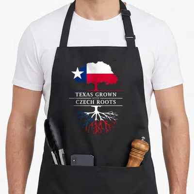 Grown texas apron - Tree with canopy and roots in white blue and red flag colors with printed text — shown on a black cotton canvas apron against a white background