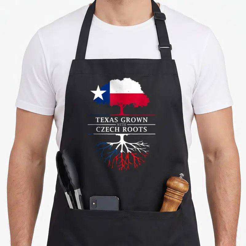 Grown texas apron - Tree with canopy and roots in white blue and red flag colors with printed text — shown on a black cotton canvas apron against a white background