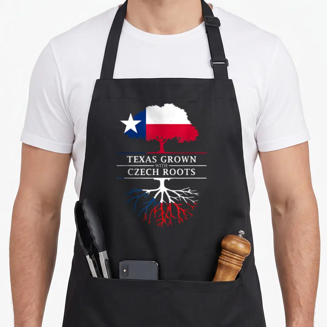 Grown texas apron - Tree with canopy and roots in white blue and red flag colors with printed text — shown on a black cotton canvas apron against a white background