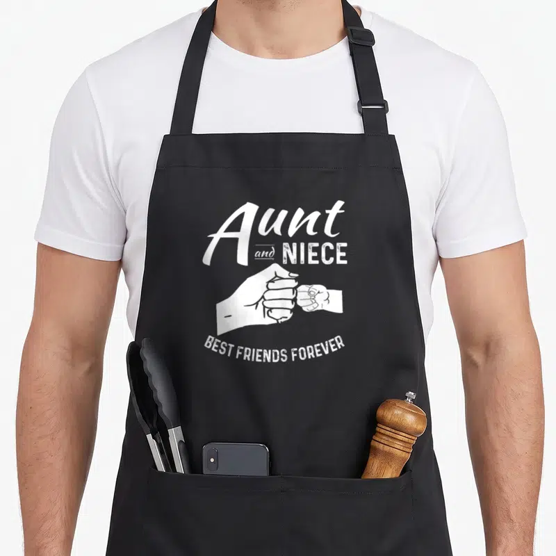 Outfit niece apron - White text Aunt Niece Best Friends Forever with two hands pinky swearing — shown on a black cotton canvas apron against a white background