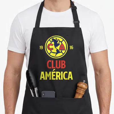 Our exclusive collection apron - Club América logo with map, 1916 dates, and red yellow blue text — shown on a black cotton canvas apron against a white background
