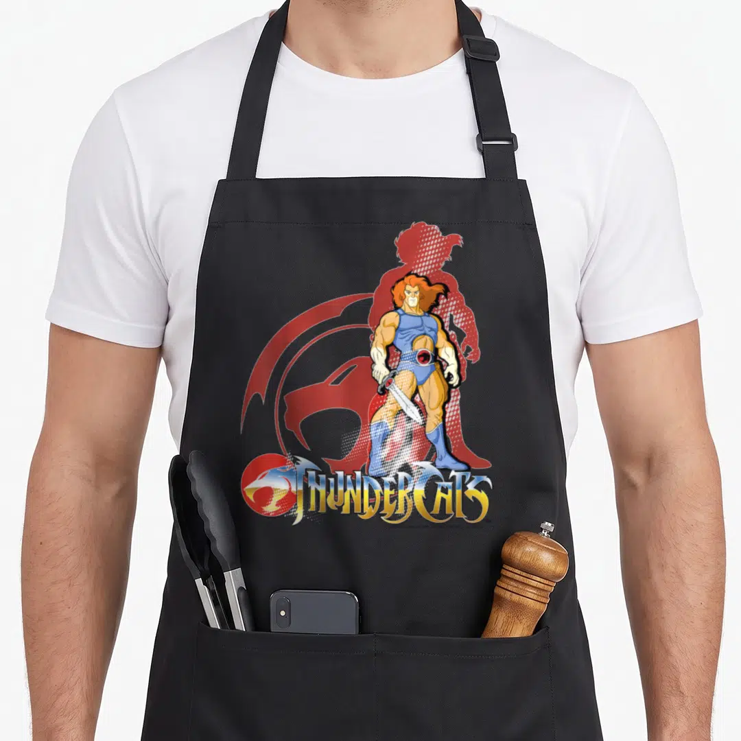 Funny lion apron - Lion-O holding sword with red halftone silhouette and THUNDERCATS logo in cartoon style — shown on a black cotton canvas apron against a white background