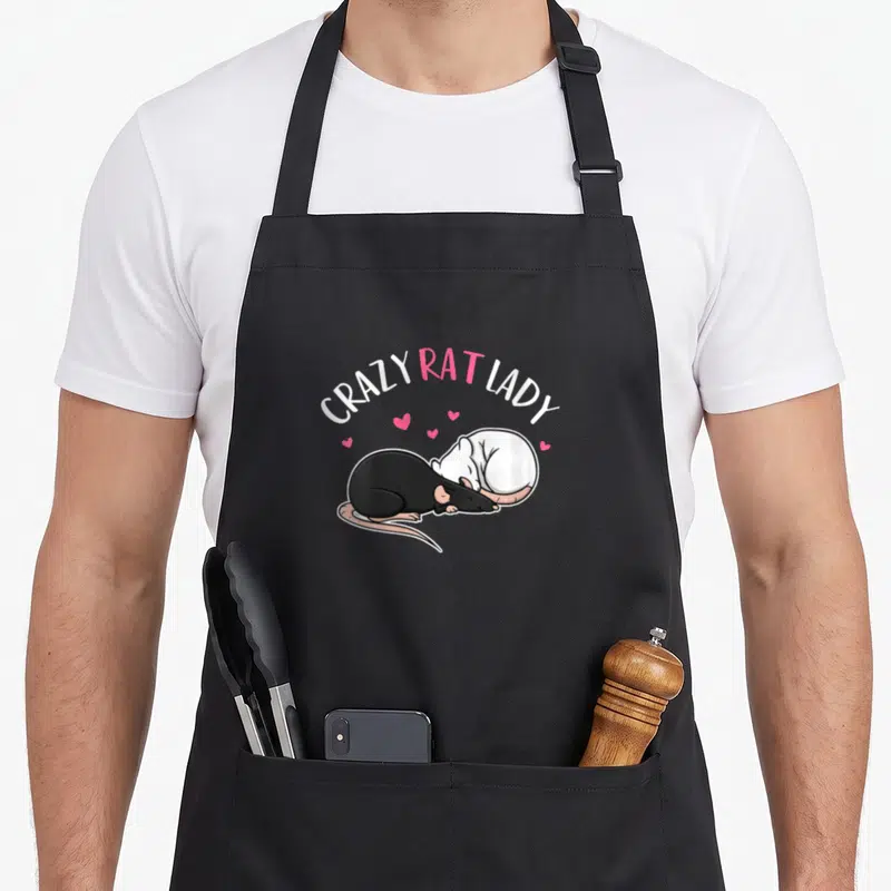 Crazy rat gal apron - Two rats curled together under CRAZY RAT LADY text with pink hearts — shown on a black cotton canvas apron against a white background