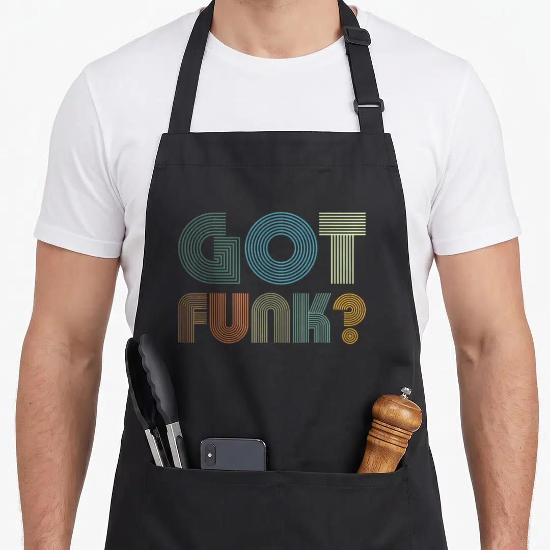 Funk vintage inspired apron - Stacked GOT FUNK? text in green blue yellow orange retro linear font — shown on a black cotton canvas apron against a white background