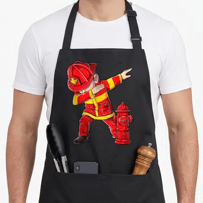 Dabbing firefighter apron - Cartoon fireman dabbing pose with red hydrant in red and yellow graphic art style — shown on a black cotton canvas apron against a white background