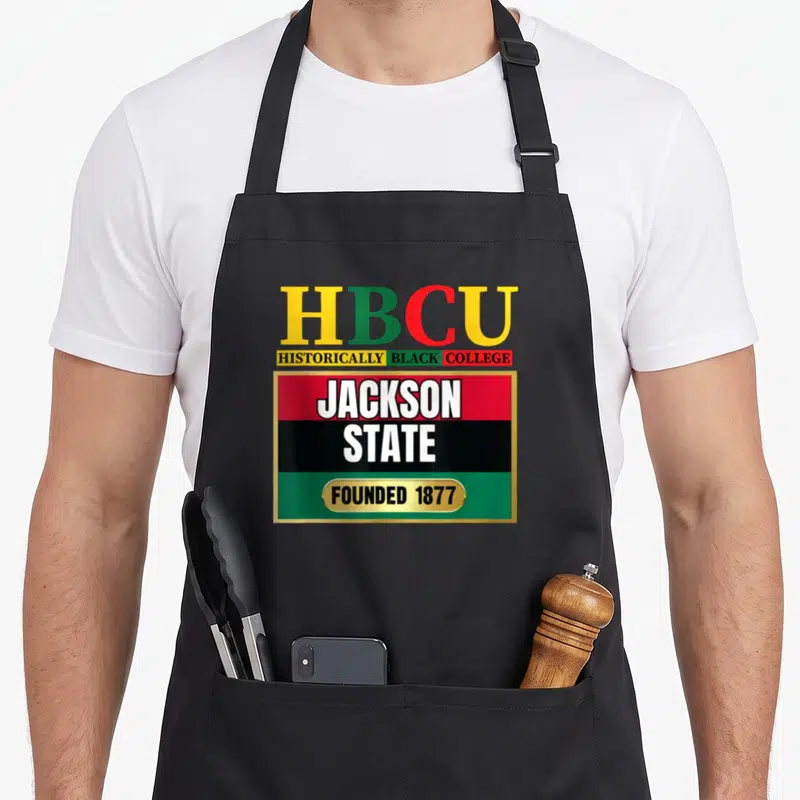 Jsu state university apron - HBCU typography with red black and green stripes and gold border reading Jackson State — shown on a black cotton canvas apron against a white background