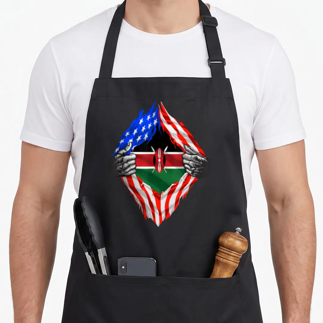 Kenyan heritage aprons - Hands tearing USA flag revealing Kenyan flag with red white blue green and black colors — shown on a black cotton canvas apron against a white background
