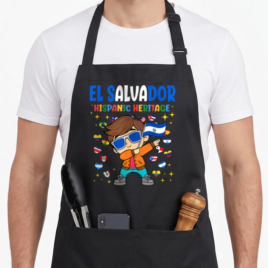 Proud salvadoran apron - Cartoon boy holding El Salvador flag surrounded by heart-shaped flags and stars with text — shown on a black cotton canvas apron against a white background