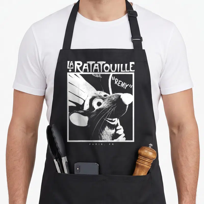 Faded remy ratatouille apron - Distressed white graphic of Remy the rat chef inside a frame with LA RATATOUILLE — shown on a black cotton canvas apron against a white background