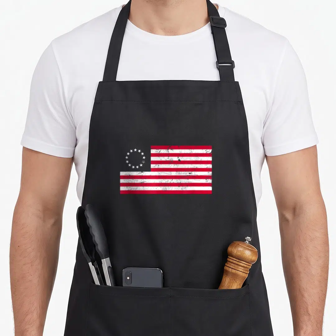 Distressed ross aprons - Red and white flag with circle of stars in distressed style — shown on a black cotton canvas apron against a white background