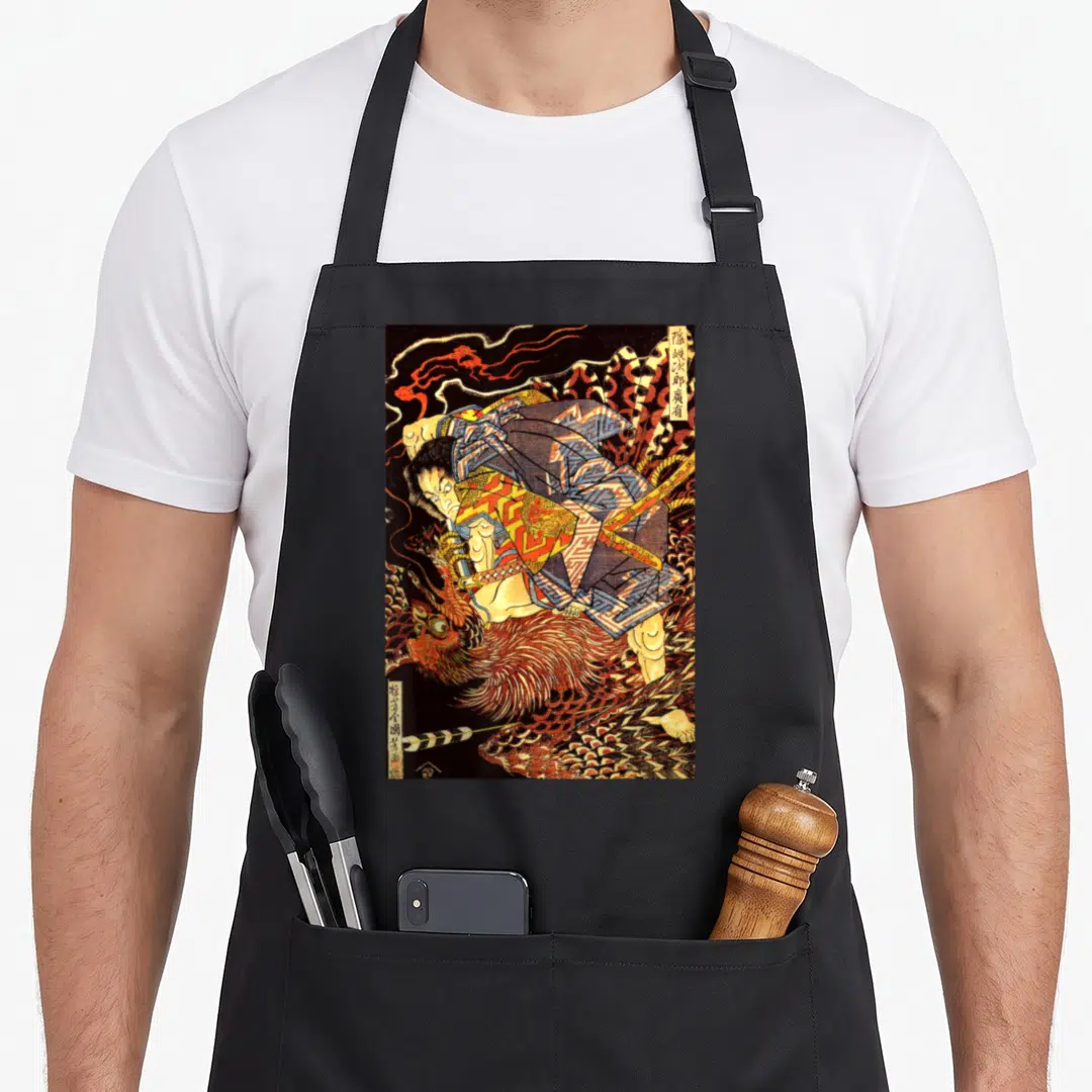 Japanese phoenix apron - Vintage samurai wrestling a phoenix with vertical Japanese calligraphy in black, red, and gold — shown on a black cotton canvas apron against a white background