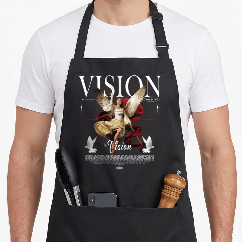Modern streetwear apron - Angel with red cloth and two doves below large VISION text and inspirational quote — shown on a black cotton canvas apron against a white background