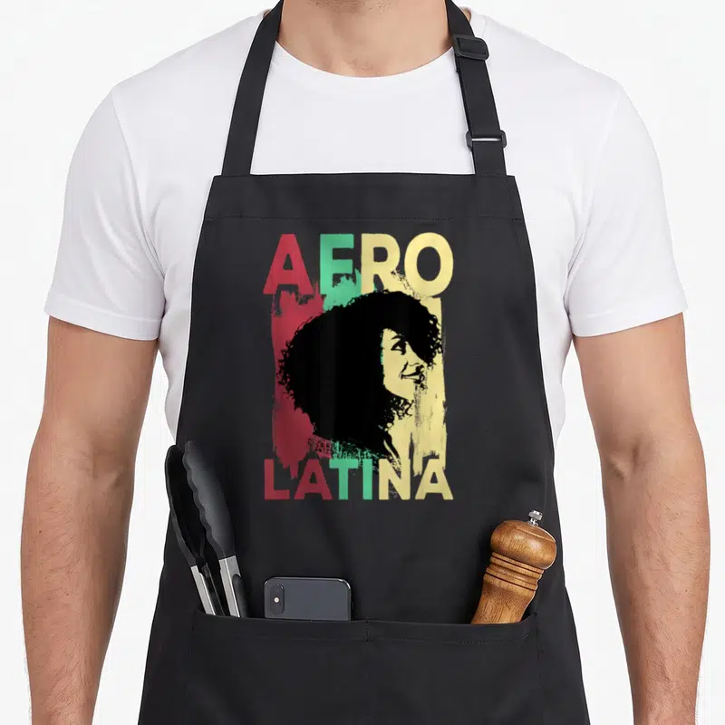 Latinx pride apron - AFRO LATINA text with woman silhouette over red green yellow paint splash — shown on a black cotton canvas apron against a white background