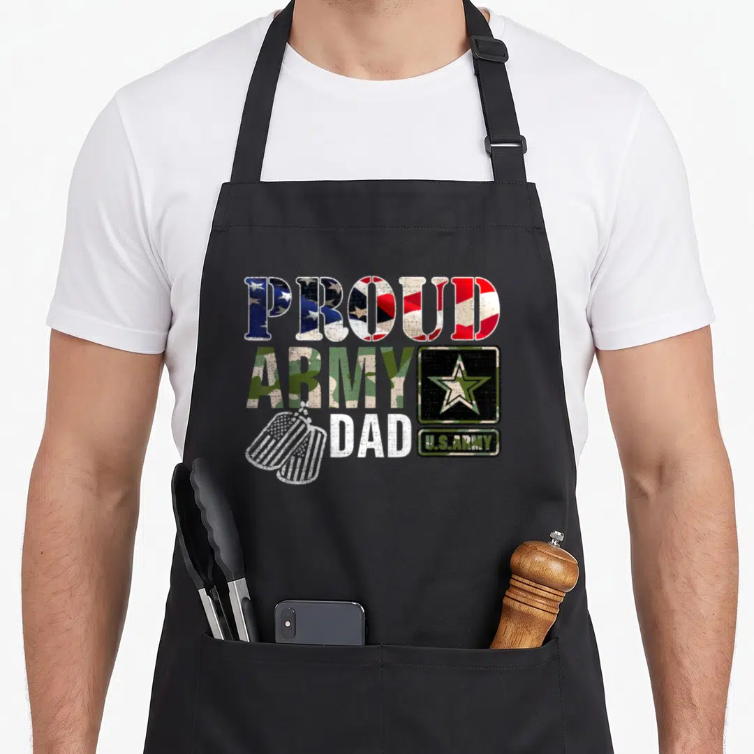 Proud army camo apron - Distressed PROUD ARMY DAD text with US flag fill, star logo, and dog tags in red white blue — shown on a black cotton canvas apron against a white background