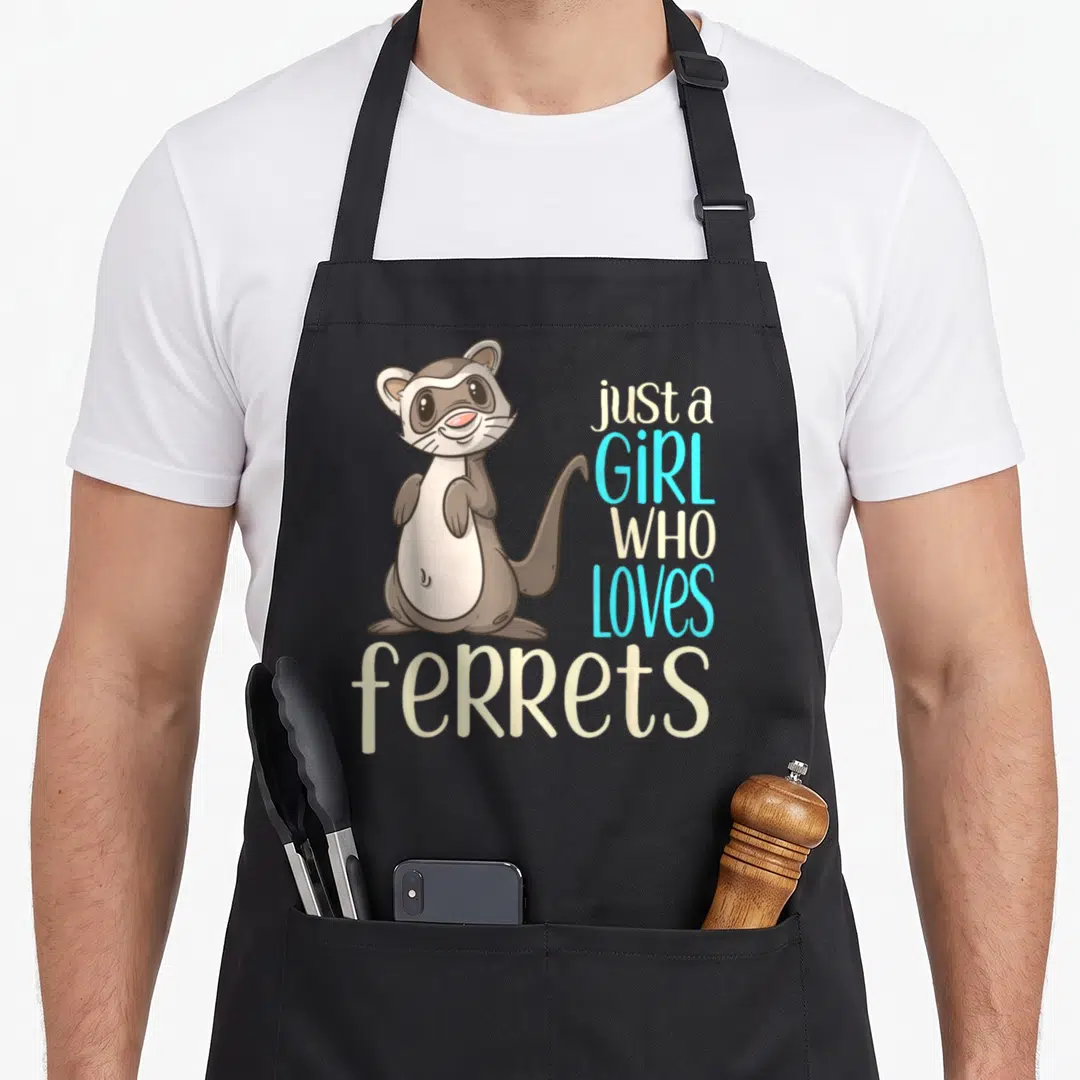 Funny crazy ferret lady apron - Cartoon brown ferret standing next to stacked text reading just a girl who loves ferrets — shown on a black cotton canvas apron against a white background