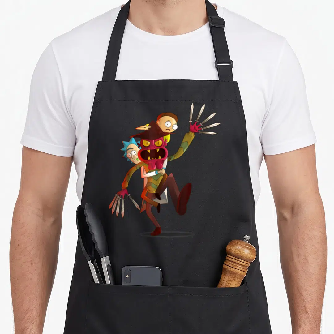 Nightmare x apron - Red monster with blade fingers carrying two men in cartoon style with red brown blue and green — shown on a black cotton canvas apron against a white background