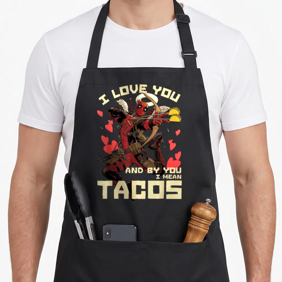 Cupid taco apron - Deadpool archer with tacos targets and red hearts under arched text — shown on a black cotton canvas apron against a white background
