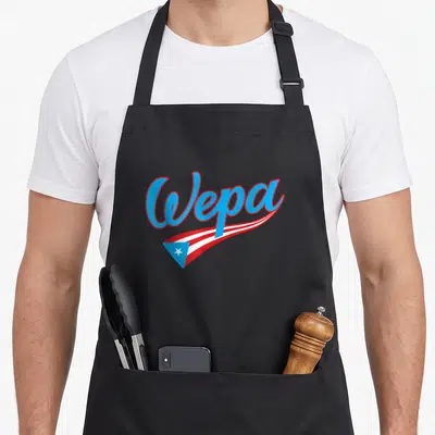 Wepa puerto apron - Blue script Wepa text above red and white waving flag with blue triangle and white star — shown on a black cotton canvas apron against a white background