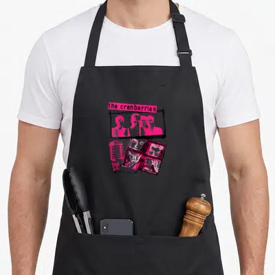 Cranberry baseball apron - Pink and black collage of band members, microphone, and ZOMBIE text — shown on a black cotton canvas apron against a white background