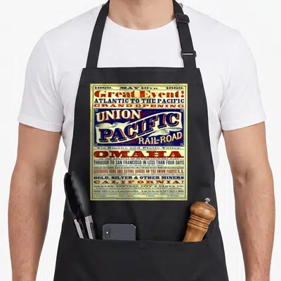 Wild union aprons - 1869 Union Pacific Railroad vintage poster with beige red blue black text — shown on a black cotton canvas apron against a white background