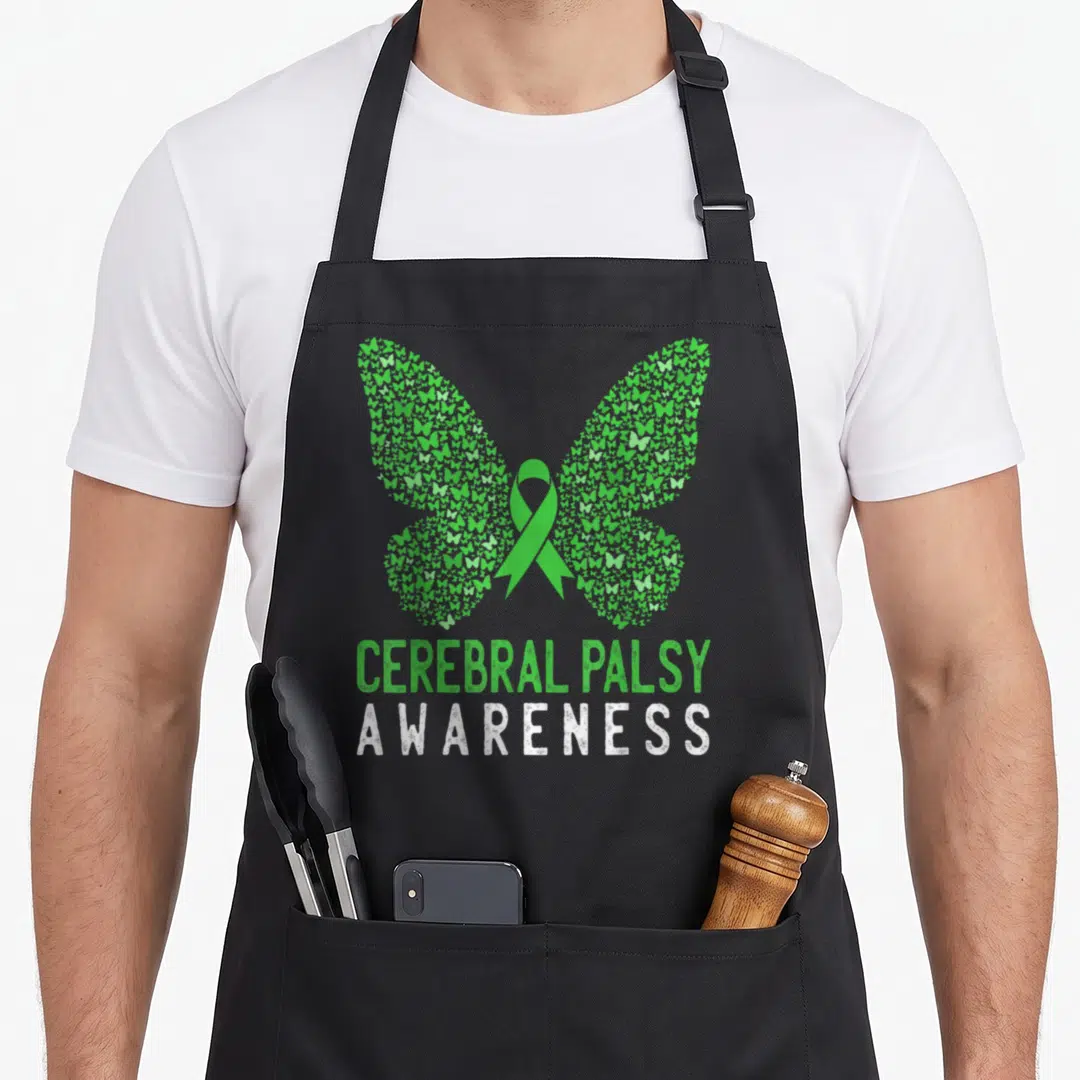 Cerebral butterfly apron - Green butterfly mosaic with ribbon and stacked Cerebral Palsy Awareness text — shown on a black cotton canvas apron against a white background