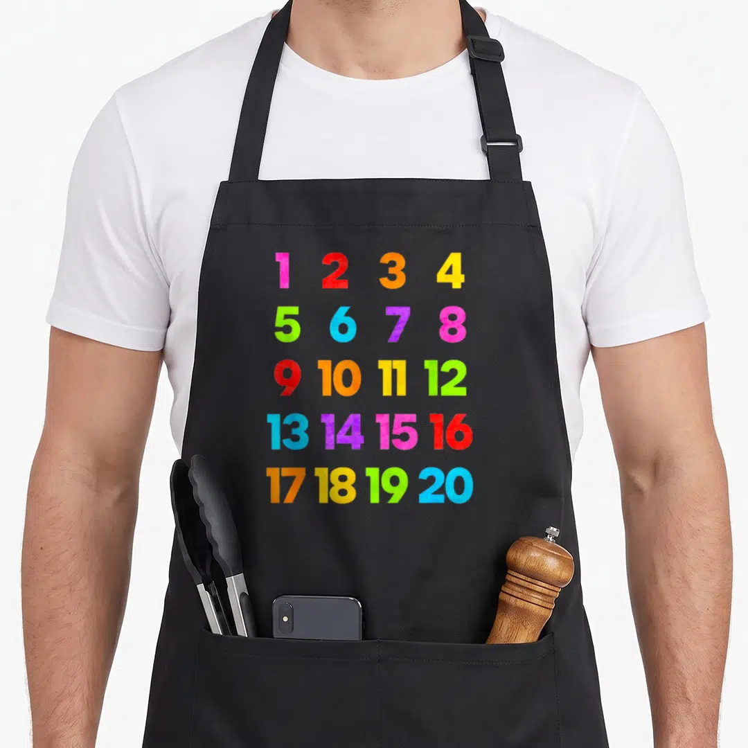 Learn teacher apron - Five rows of colorful numbers 1 through 20 in pink red orange yellow green blue and purple — shown on a black cotton canvas apron against a white background
