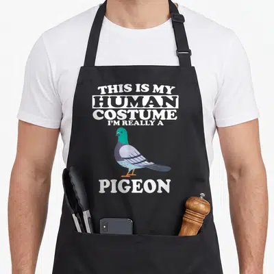 Human costume i love my pigeon apron - Cartoon pigeon with green neck and grey wings between white text reading This Is — shown on a black cotton canvas apron against a white background
