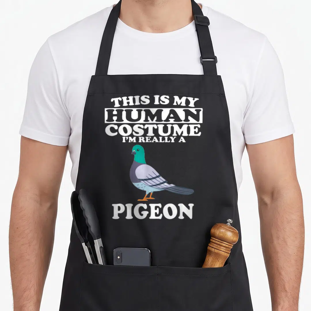 Human costume i love my pigeon apron - Cartoon pigeon with green neck and grey wings between white text reading This Is — shown on a black cotton canvas apron against a white background