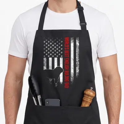English american flag apron - Bulldog silhouette on distressed flag with white paw prints and vertical red text — shown on a black cotton canvas apron against a white background